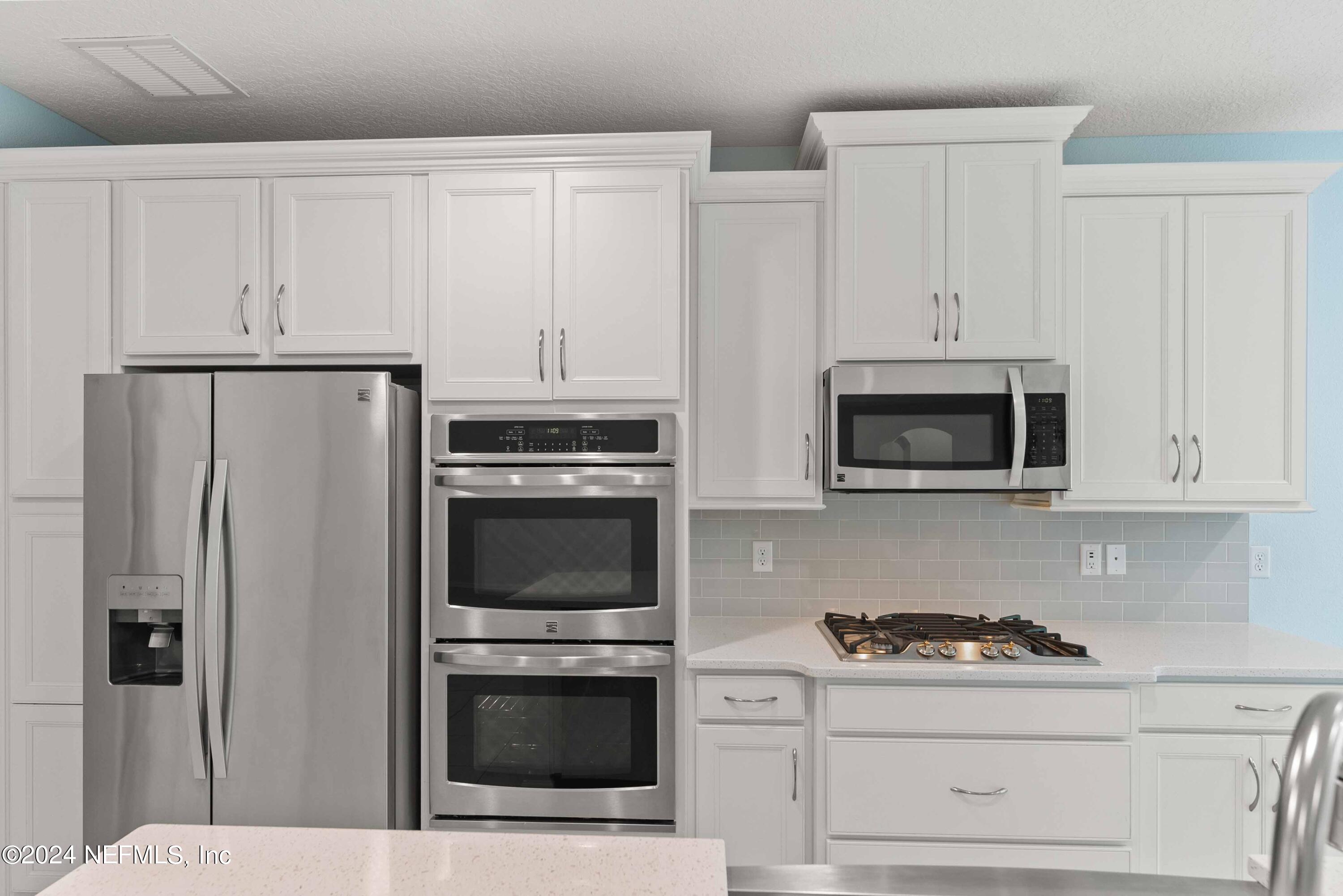 15 Greenview Lane St. Augustine, FL 32092 - Photo 13 of 41 a kitchen with white cabinets and stainless steel appliances