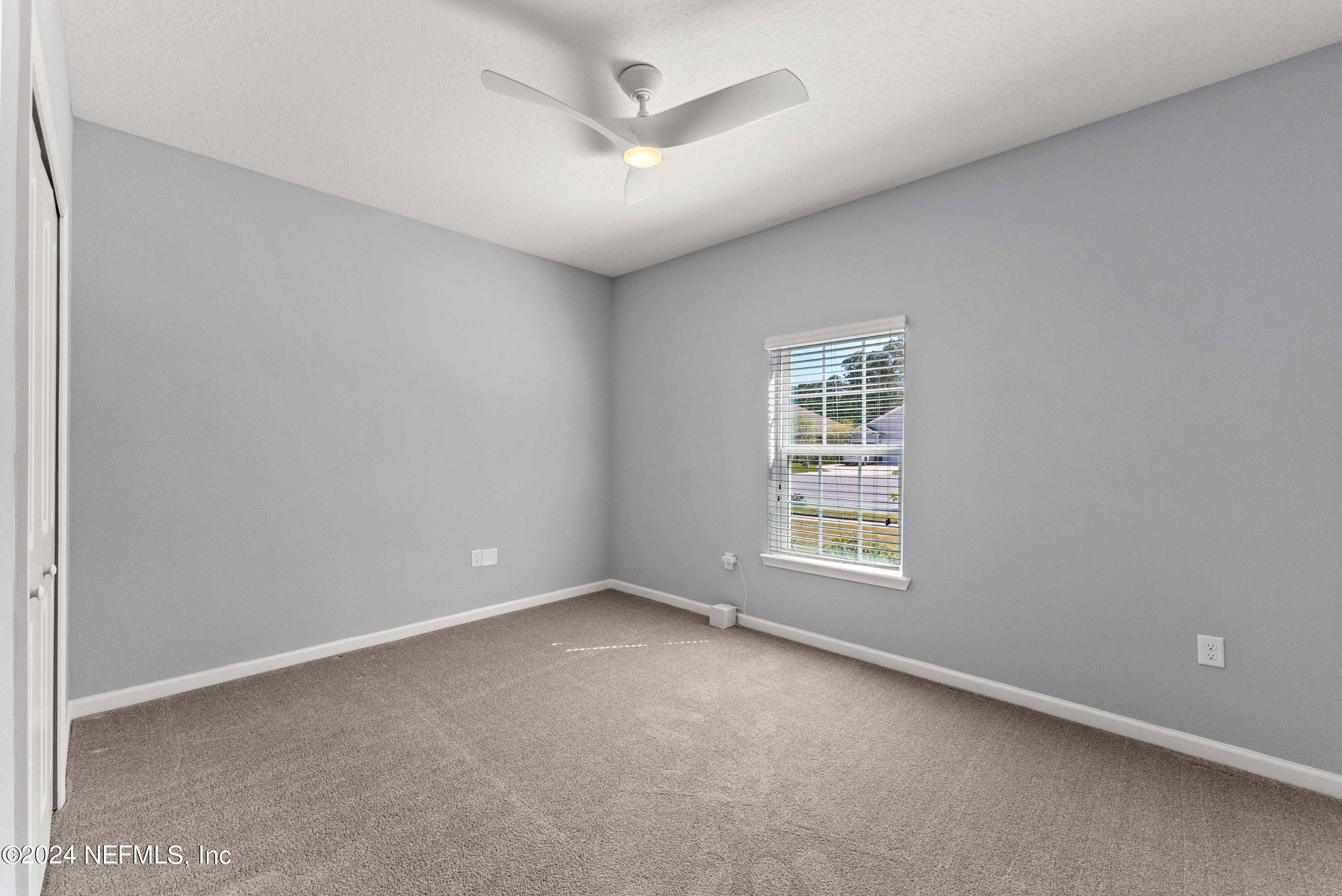 15 Greenview Lane St. Augustine, FL 32092 - Photo 16 of 41 an empty room with a window and a ceiling fan