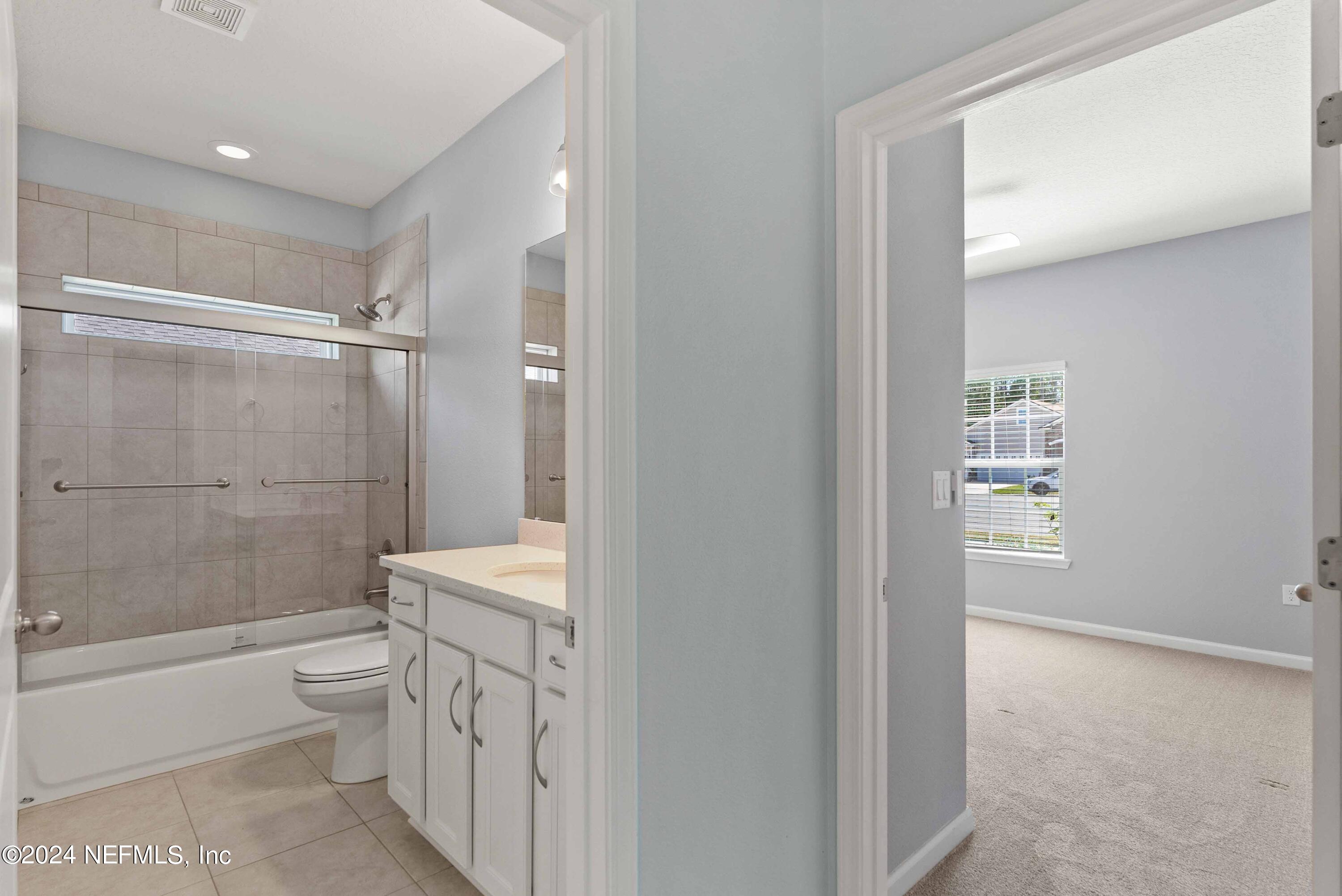 15 Greenview Lane St. Augustine, FL 32092 - Photo 18 of 41 a bathroom with a granite countertop sink a toilet and shower