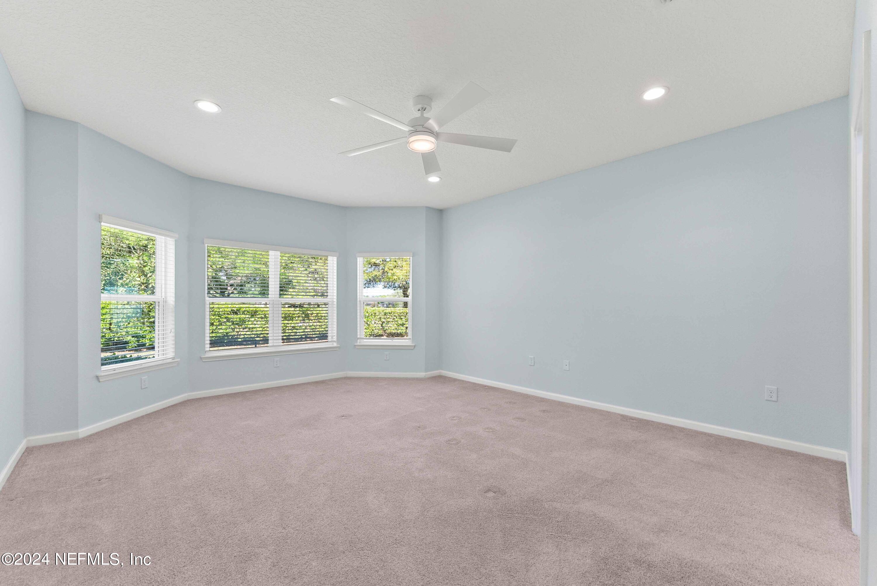 15 Greenview Lane St. Augustine, FL 32092 - Photo 23 of 41 an empty room with windows and ceiling fan