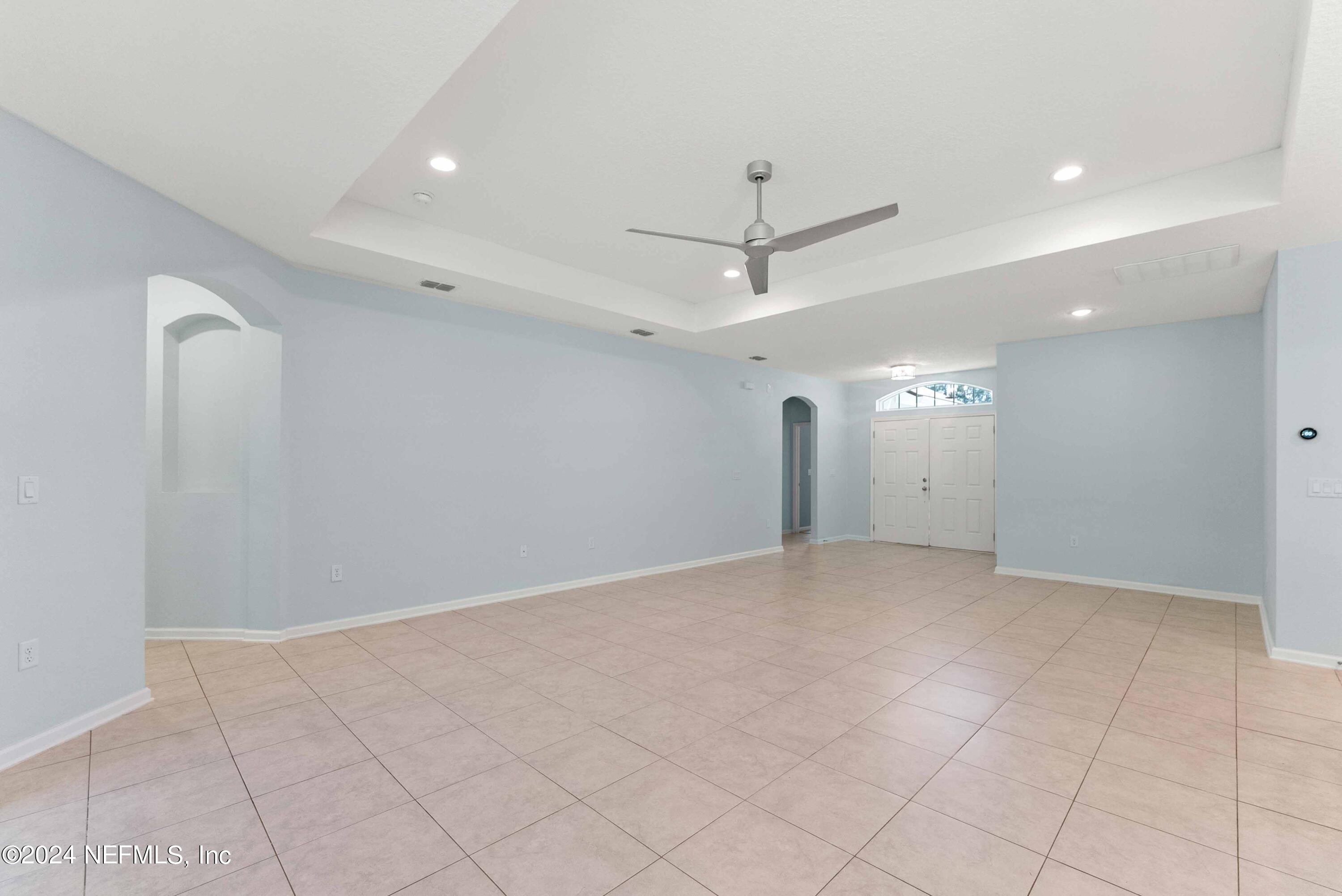 15 Greenview Lane St. Augustine, FL 32092 - Photo 6 of 41 an empty room with chandelier fan and kitchen view