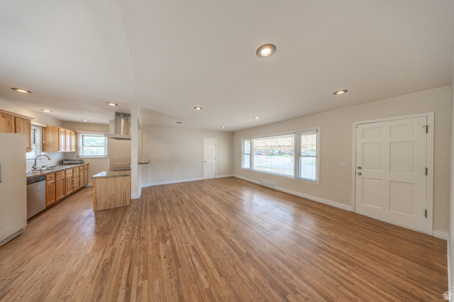 193 Locust Street Clearfield, UT 84015 - Photo 4 of 29 Open-concept living area with wood-finish flooring extending into the kitchen