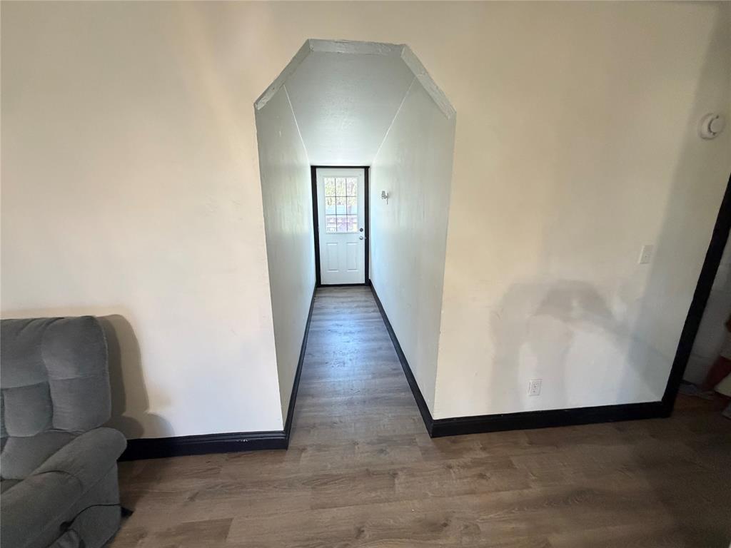 222 Hix Road Cleburne, TX 76031 - Photo 13 of 27 a view of a hallway with wooden floor and glass door