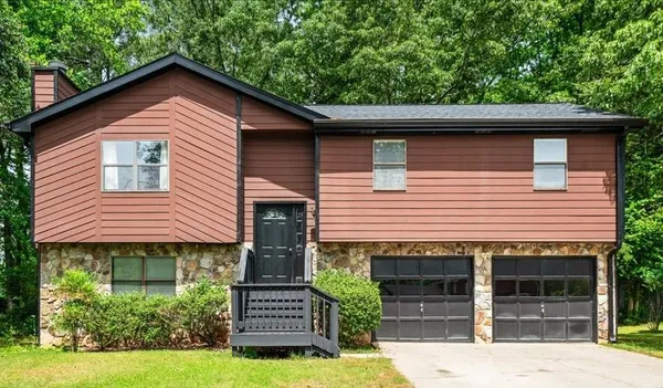 a front view of a house with a yard