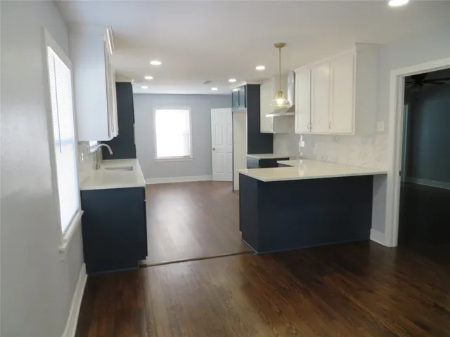 a kitchen with kitchen island sink refrigerator and stove