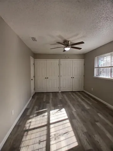 a view of a livingroom with wooden floor and window