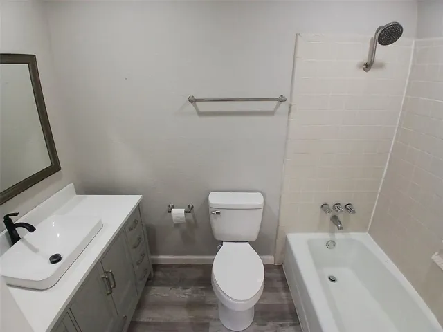 a bathroom with a sink mirror vanity and toilet