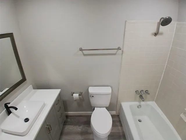 a white toilet sitting next to a bathroom sink