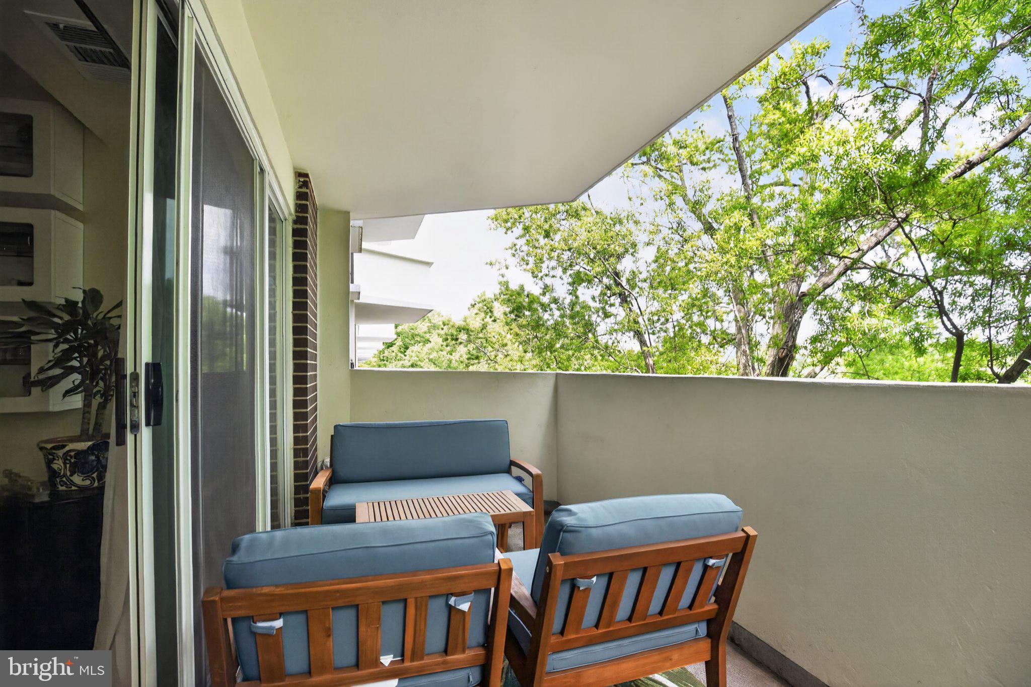 700 7th Street Southwest, Unit 526 Washington, DC 20024 - Photo 15 of 33 Serene balcony with lush greenery views.