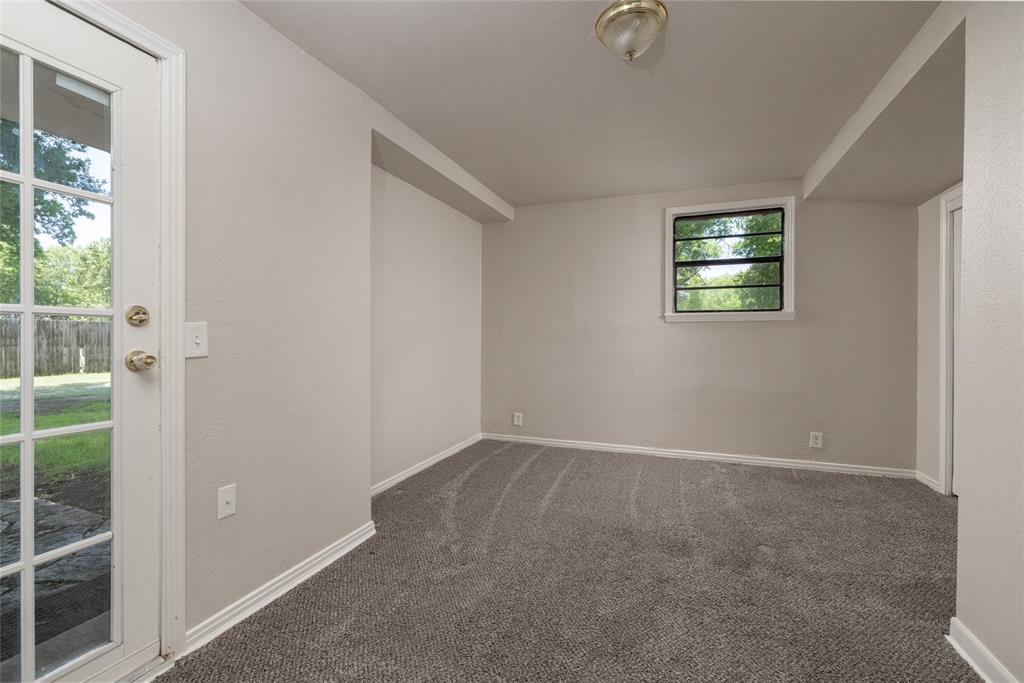 313 North Roe Street White Settlement, TX 76108 - Photo 17 of 33 Carpeted interior space featuring a glass-paneled exterior door, a rear-facing window, recessed lighting, and neutral wall finishes