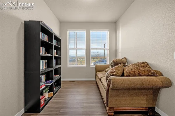 a living room with furniture and a book shelf