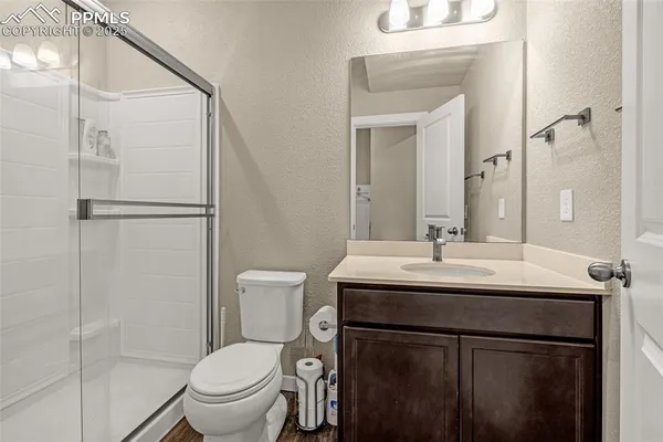 a bathroom with a toilet a sink and a mirror