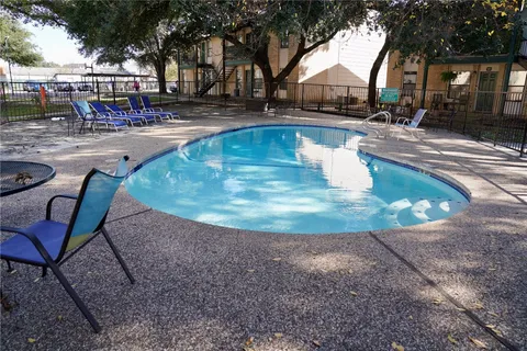 a view of yard with swimming pool and sitting space