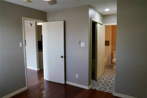 a view of a hallway with wooden floor