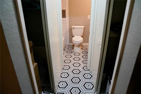 a bathroom with a toilet and a shower