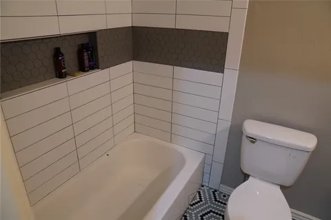 a bathroom with a bathtub and toilet