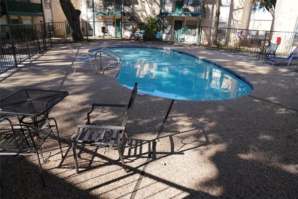 a view of a swimming pool with sitting area