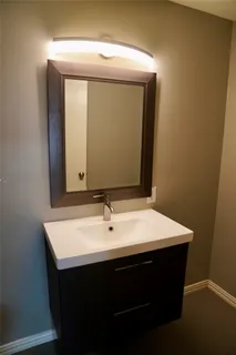 a bathroom with a sink vanity and mirror