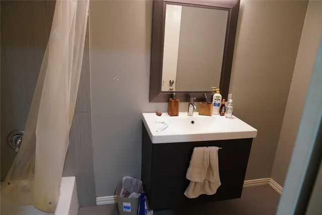 a bathroom with bathtub and shower