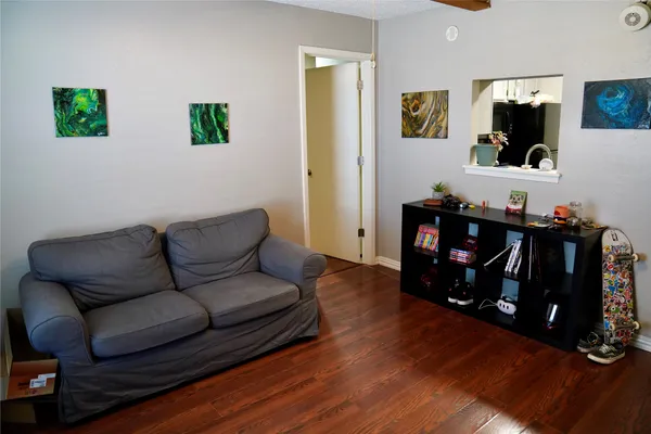 a living room with furniture and wooden floor