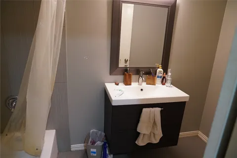 a bathroom with bathtub and shower