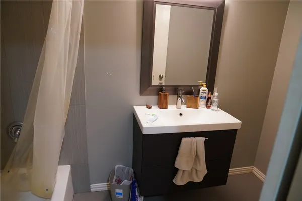 a bathroom with a sink and mirror