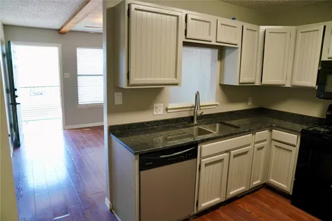 a kitchen with stainless steel appliances granite countertop a sink and a stove