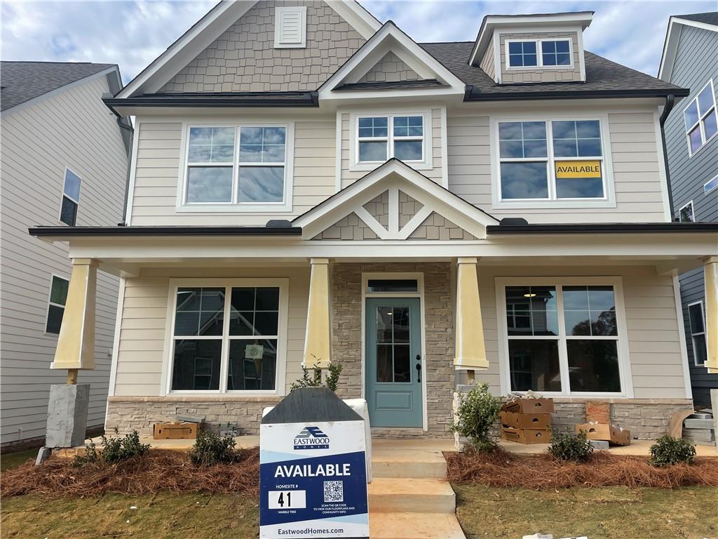 a front view of a house with a yard and glass windows