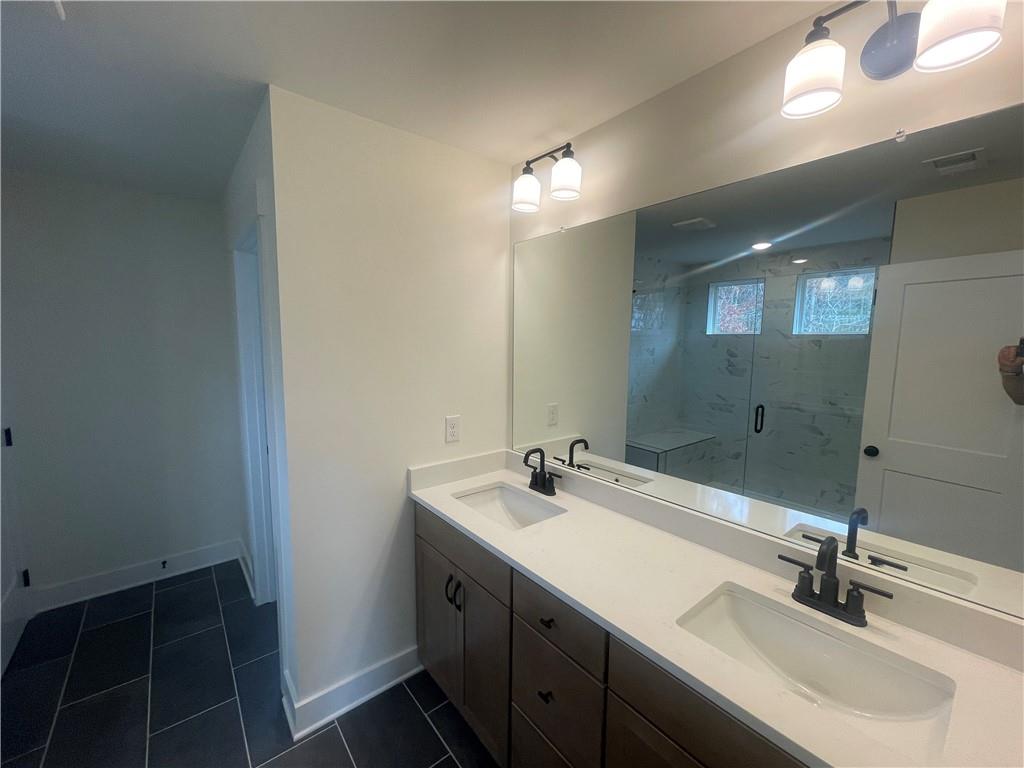 131 Marble Tree Way Ball Ground, GA 30107 - Photo 11 of 13 a bathroom with a sink double vanity and a mirror