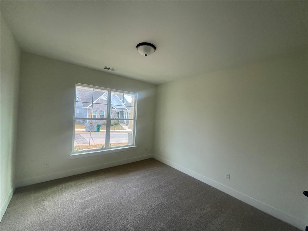 131 Marble Tree Way Ball Ground, GA 30107 - Photo 4 of 13 an empty room with a window
