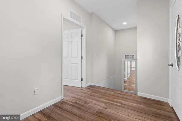 a view of room with window and wooden floor