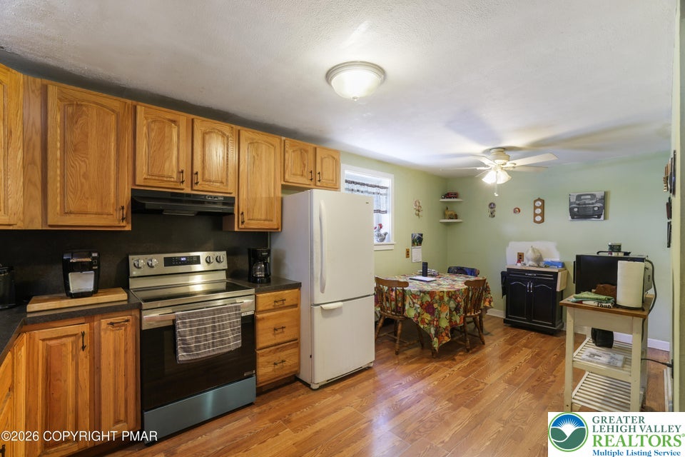 Warm wood cabinetry and durable flooring define this functional kitchen and casual dining space.