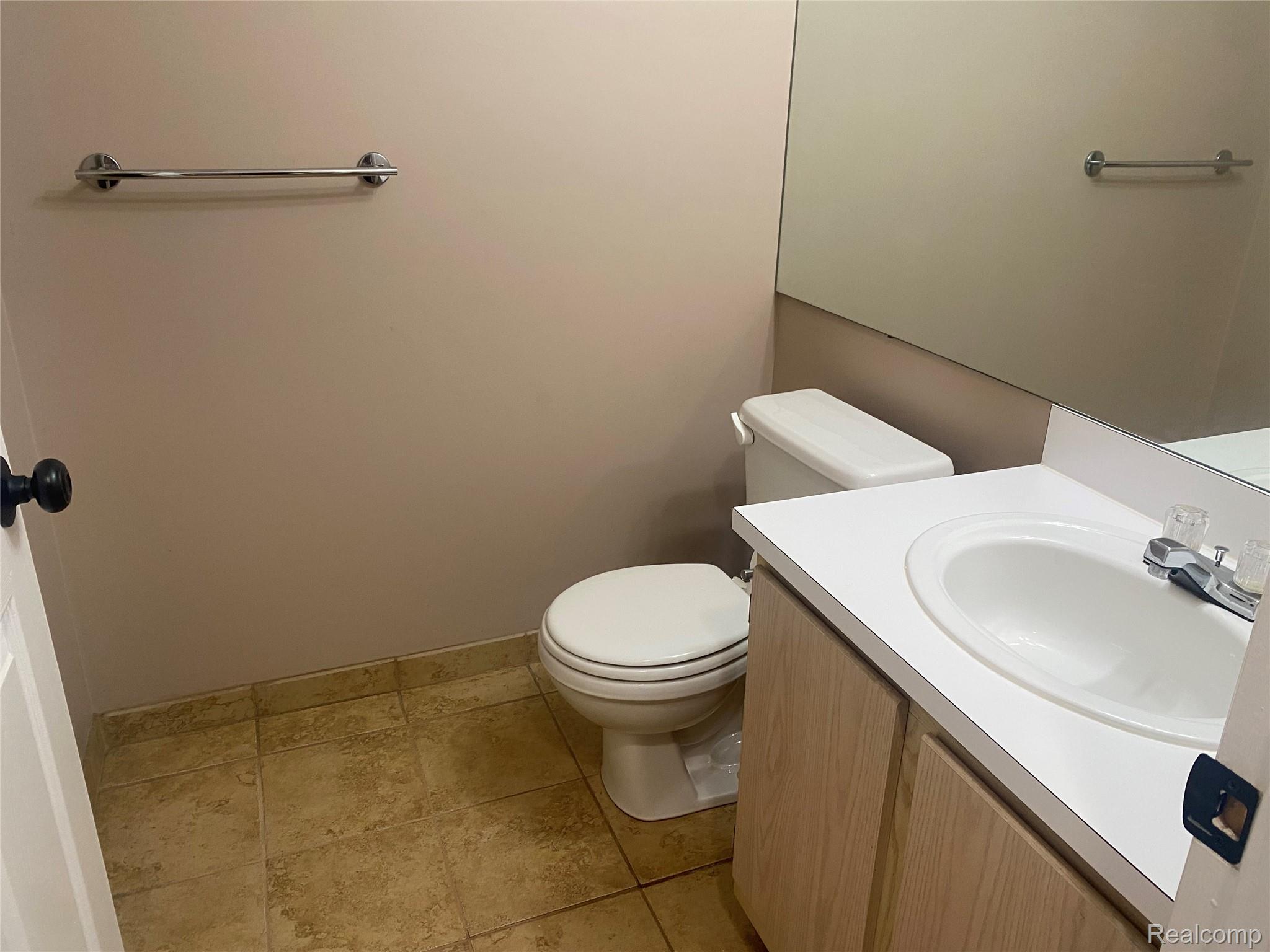 22192 Cape Cod Way Farmington, MI 48336 - Photo 10 of 17 Bathroom with tile flooring, vanity with integrated sink, chrome faucet, and expansive wall mirror