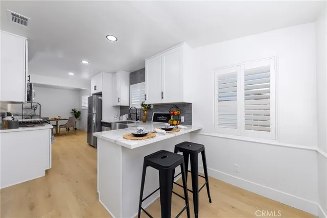 a kitchen with a stove a refrigerator and a table