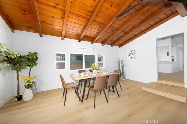 a dining room with furniture and a potted plant