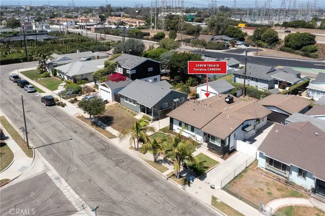 an aerial view of residential houses with outdoor space