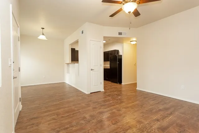 a kitchen with granite countertop a refrigerator and a sink