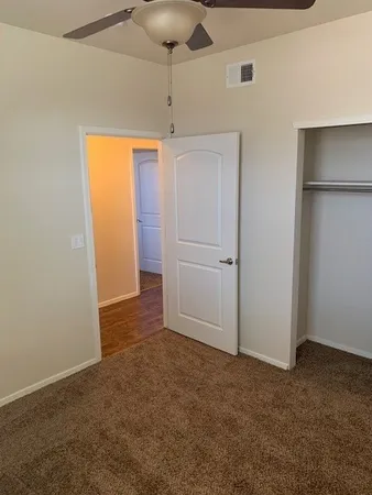a bathroom with a granite countertop sink a toilet and shower