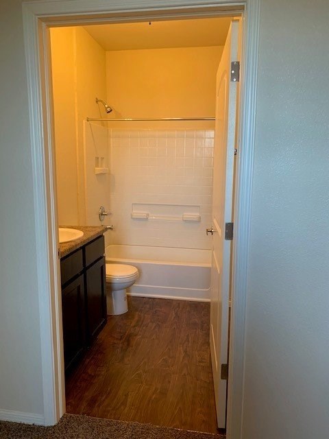 3268 North Zaragoza Road, Unit 100 El Paso, TX 79938 - Photo 6 of 6 a bathroom with a granite countertop sink a toilet and shower
