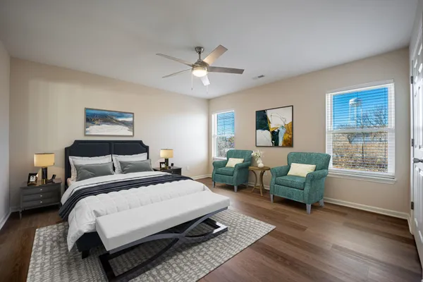 a bedroom with a bed a couch and a window