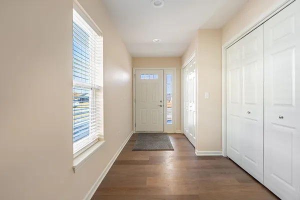 a view of a hallway with wooden floor and staircase
