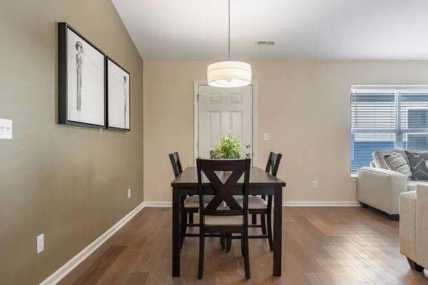 a view of a dining room with furniture and wooden floor