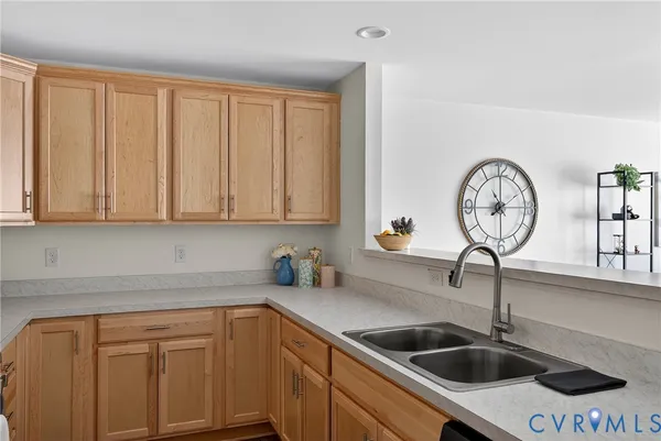 a kitchen with stainless steel appliances a sink a stove and cabinets