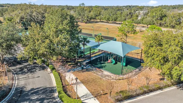 an aerial view of a house with a yard and lake view