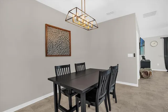 a view of a dining room that has a table and chairs in it