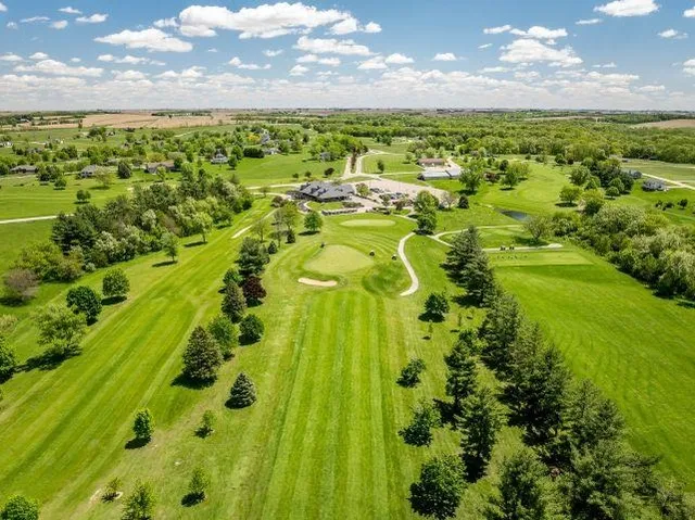 an aerial view of a house with a yard and lake view