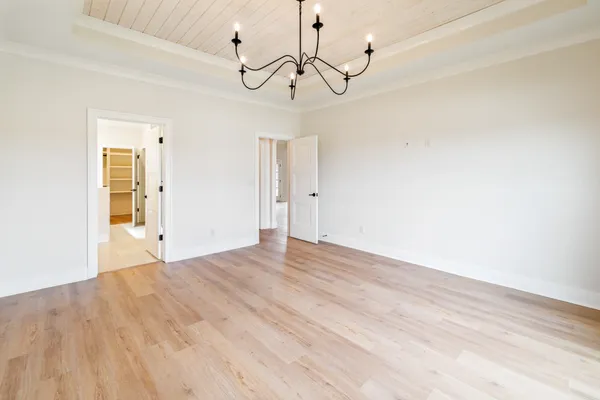a view of a living room kitchen with a fireplace and wooden floor