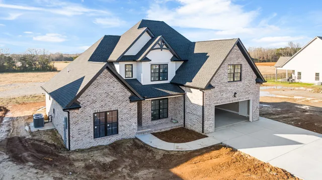 a front view of a house with yard garage and kitchen