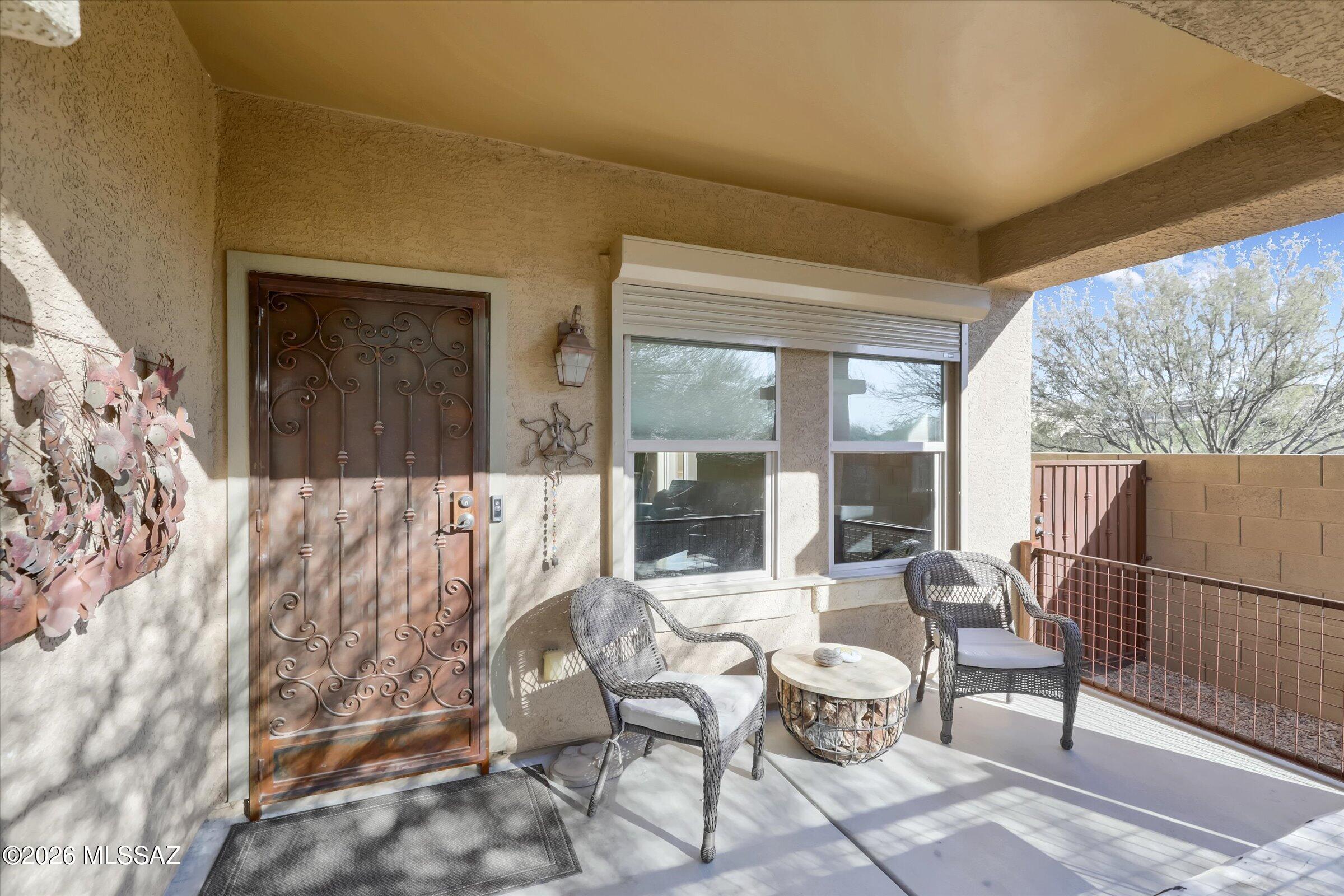 6095 South Jakemp Trail Tucson, AZ 85747 - Photo 7 of 52 a view of a balcony with chairs and a potted plant