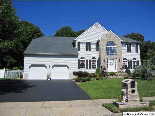 396 Meadowood Road Jackson, NJ 08527 - Photo 2 of 3 a front view of a house with a yard